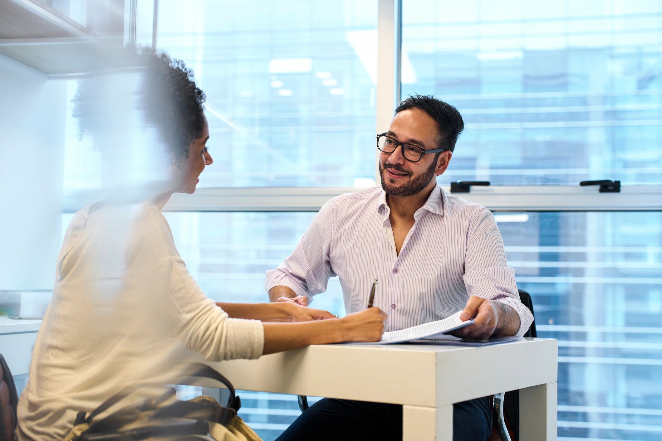 Financial advisor consulting with a client in a professional office