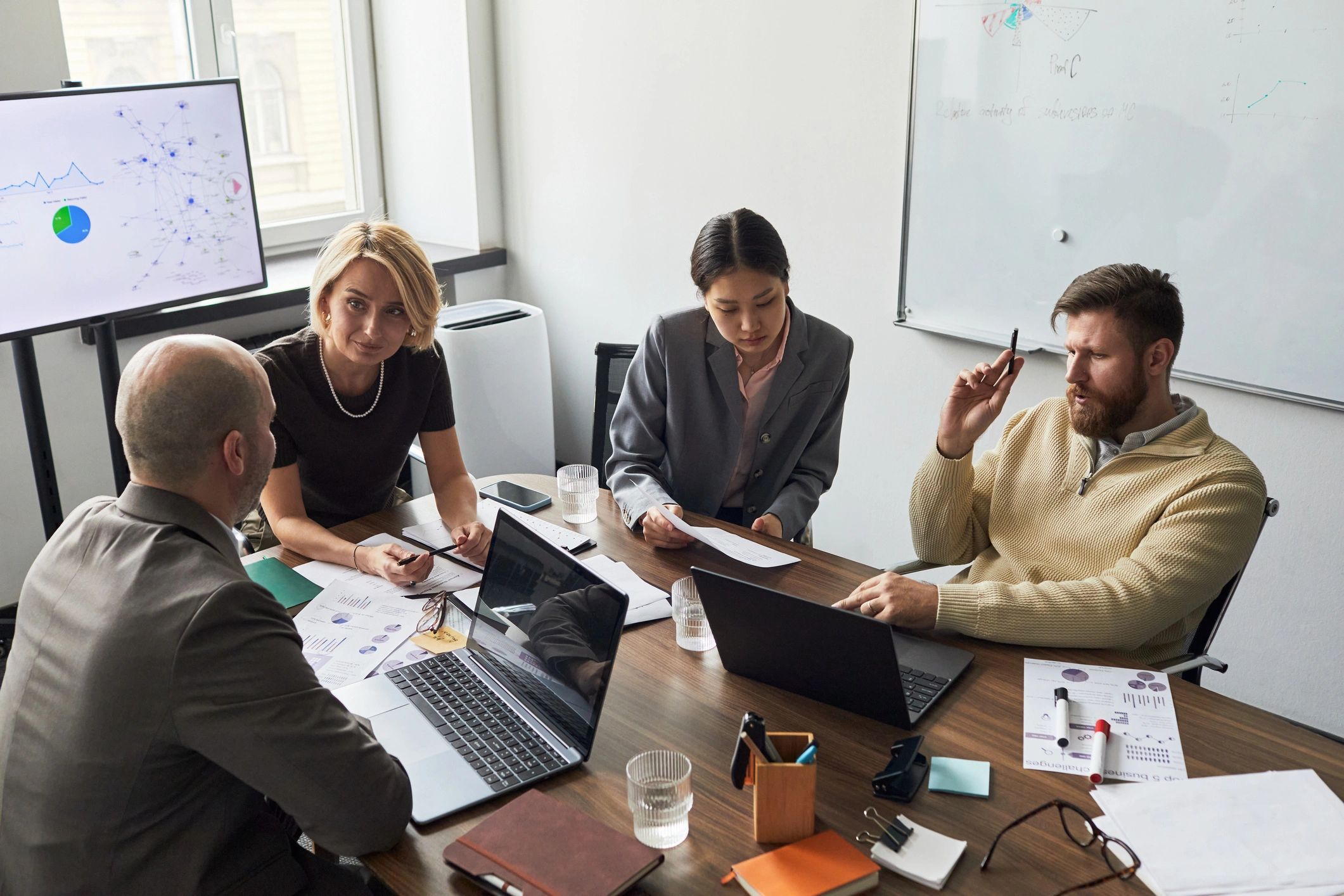 Business team reviewing reports during an office strategy meeting